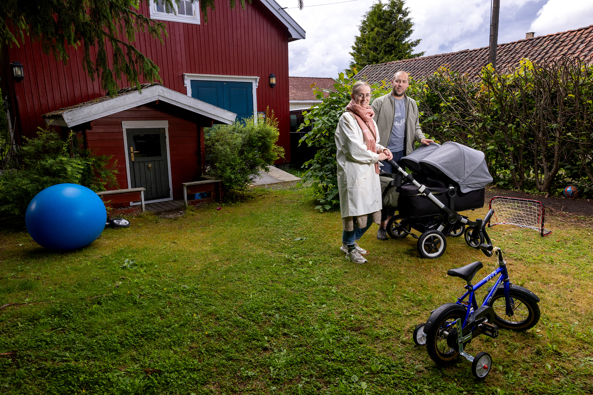 Linnéa Paulsen Luijbregts og Glenn Luijbregts i hagen med barnevognen.