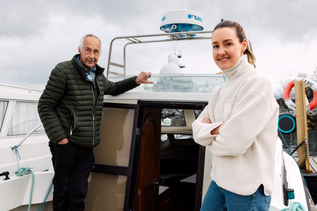 Portrett av far Thor Olsen og datter Karina Olsen Bakke på dekket av en båt. Karina reddet livet til sin far da han fikk hjertestans på båten.