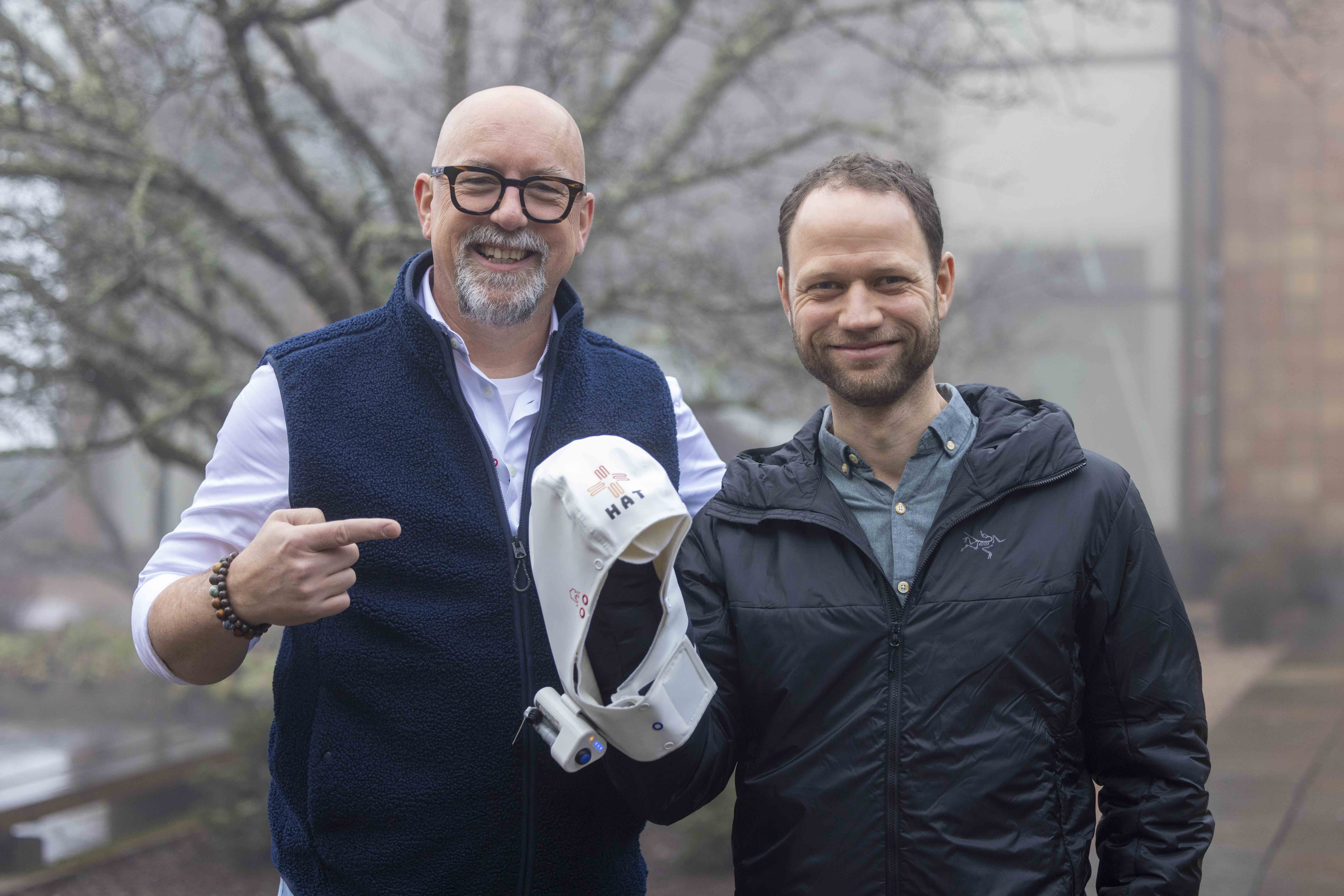 Robert Fennis, Marketing Lead for Northerm HAT, and Einar Fossli, HEMS Crew Member with the Norwegian Air Ambulance Helicopters and innovator for The Norwegian Air Ambulance Foundation, showing the hypothermia hood NORTHERM HAT.