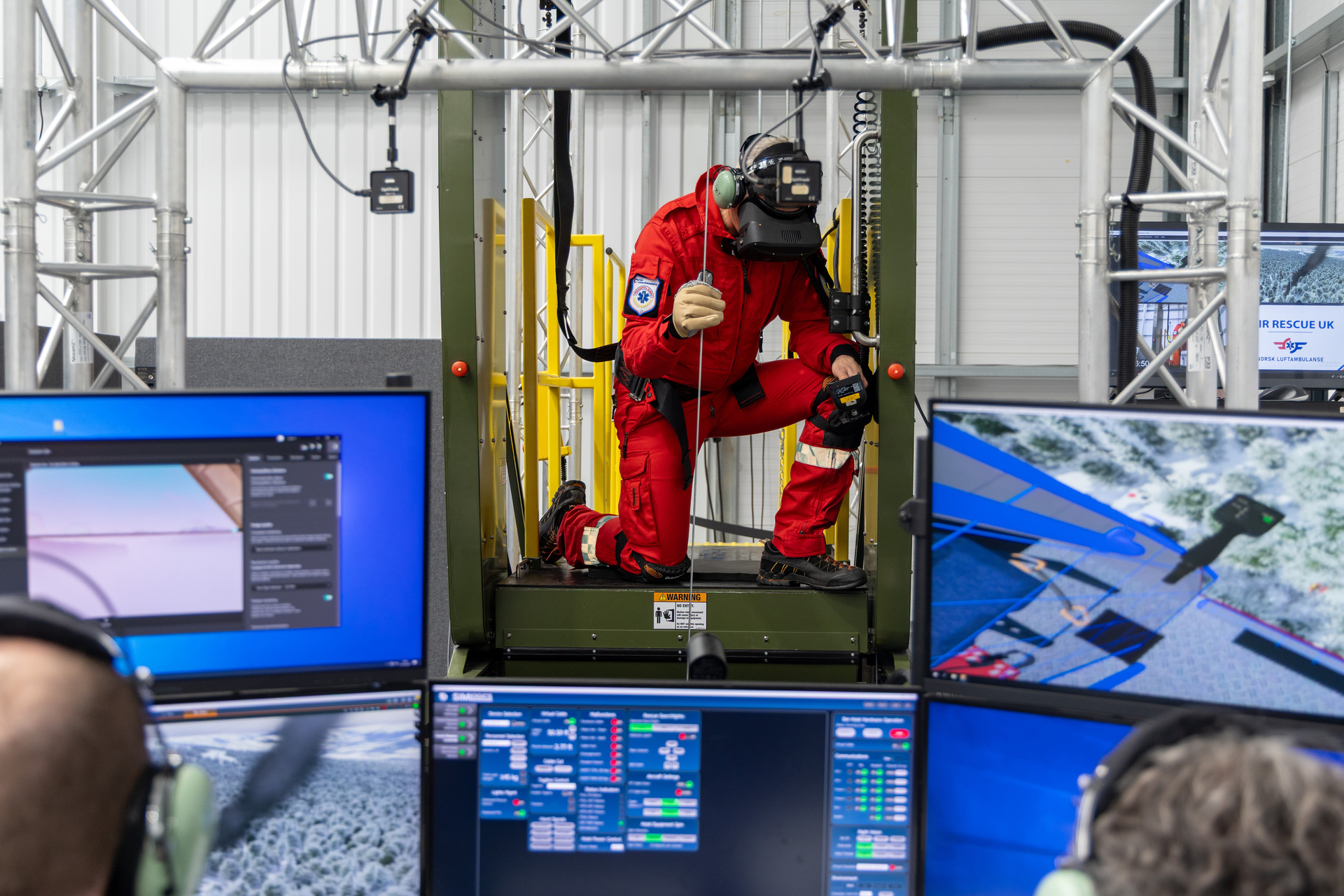 HEMS Physician Marius Rehn training for helicopter hoist operations in a simulator